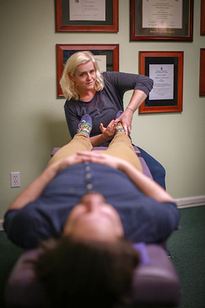 Dr. Anna Nusslock working on a patient's feet